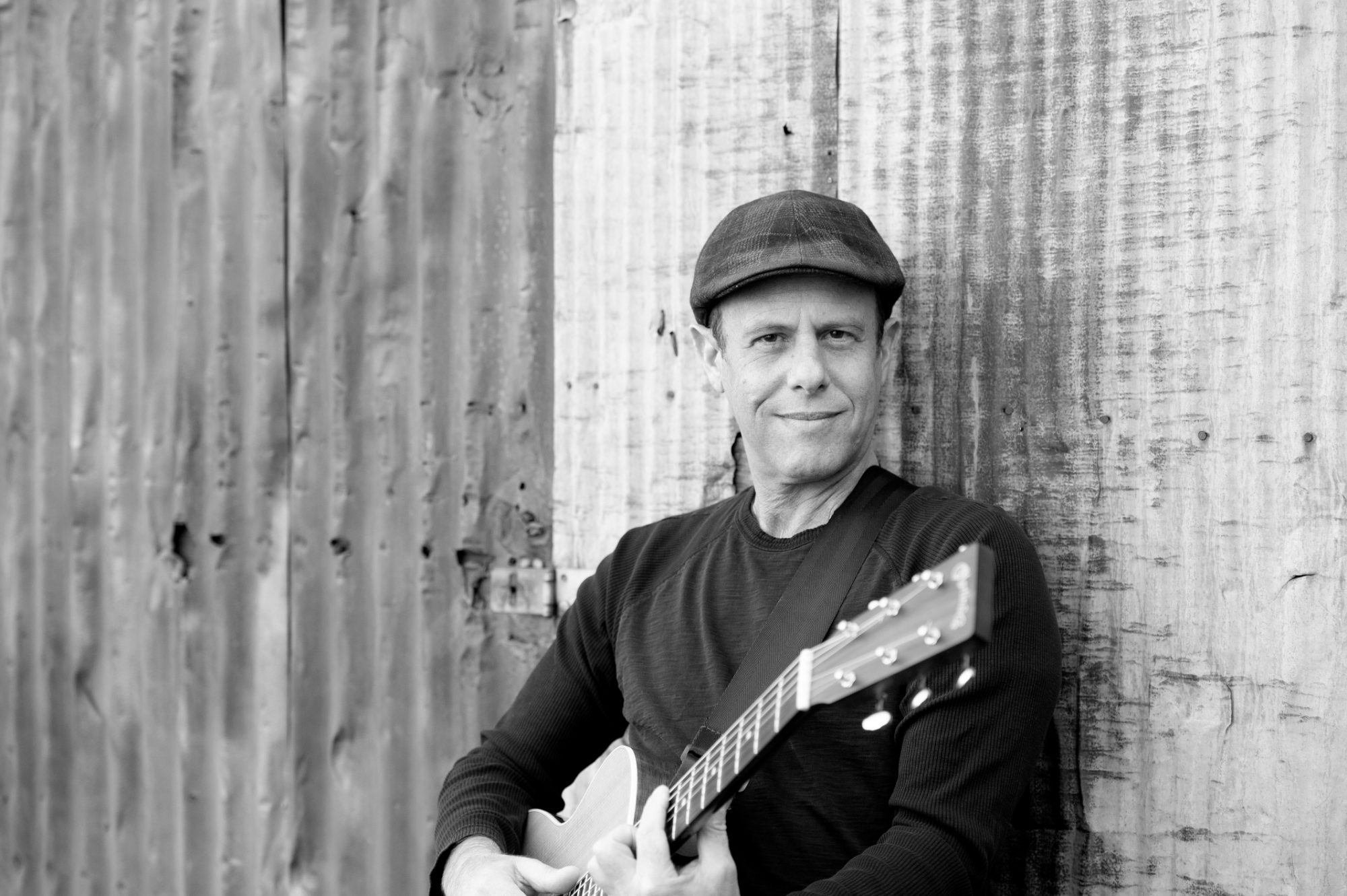 Peter Gross leaning on barn door