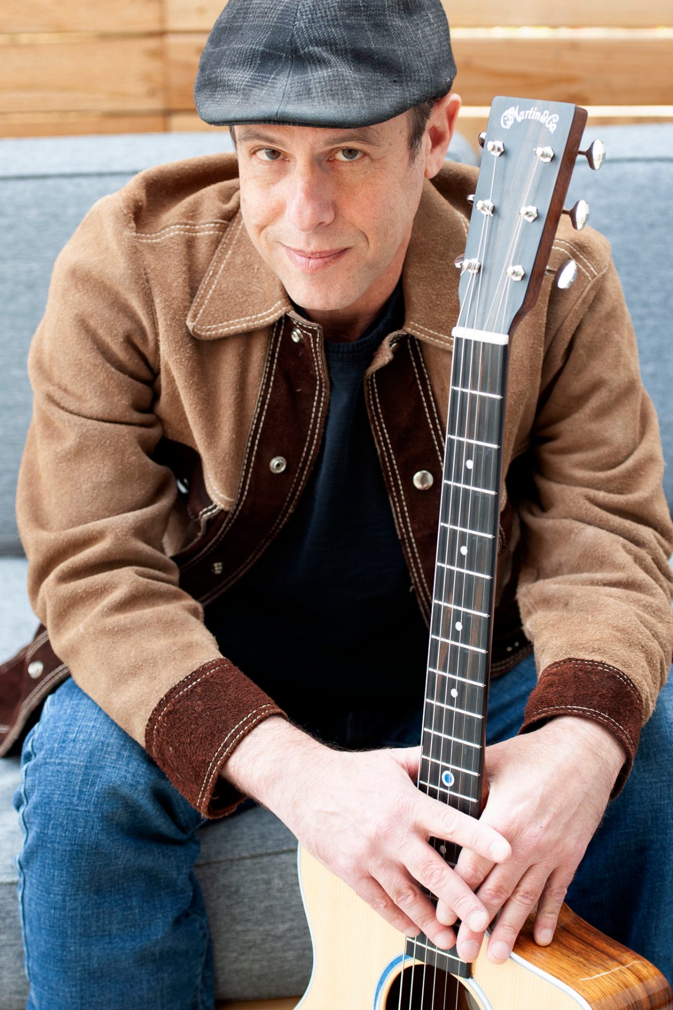 Peter Gross with Martin guitar seated